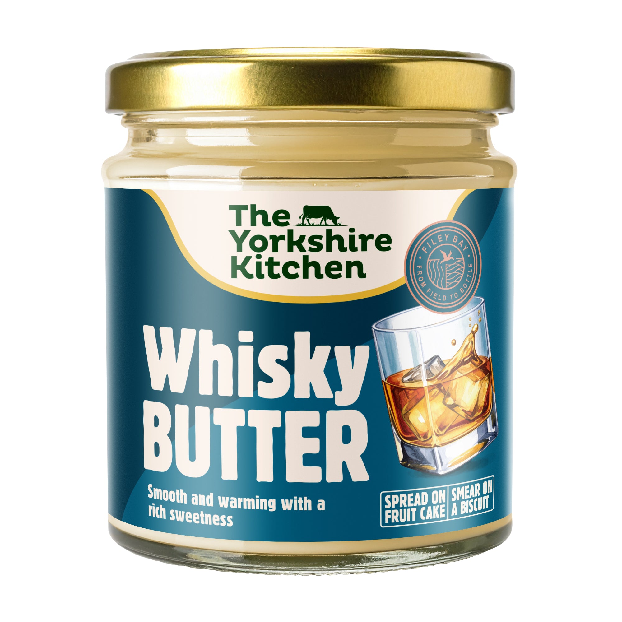 “Glass jar of The Yorkshire Kitchen Whisky Butter with a gold metal lid and teal-blue label. The label features the brand name at the top and large white text reading ‘Whisky Butter,’ alongside an image of a tumbler of whisky with ice. Additional text reads ‘Smooth and warming with a rich sweetness’ and ‘Spread on fruit cake or smear on a biscuit.